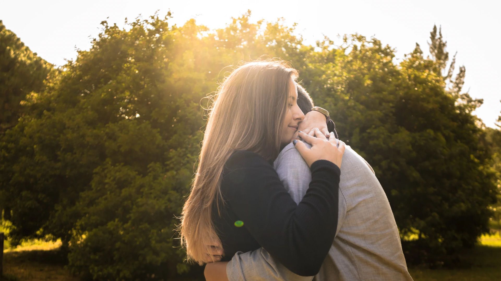 Couple embracing at sunset representing secure attachment in adult relationships